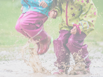 children jumping in puddle
