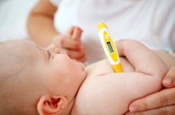baby with thermometer under armpit