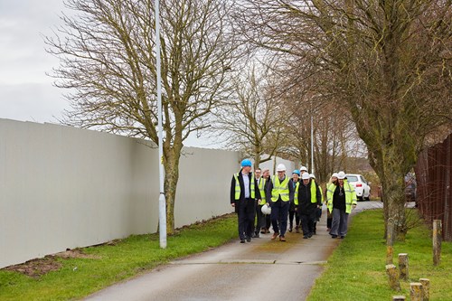 People walking along a path in high-vis and hard hats